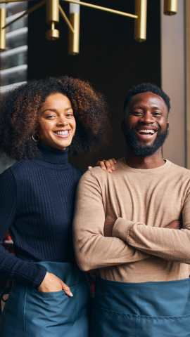 An African American male and female posing for the picture